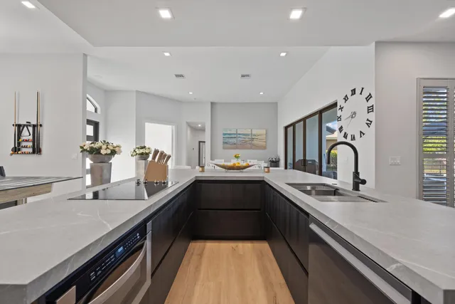 a kitchen with stainless steel appliances a sink stove and cabinets