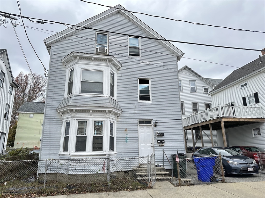 11 Foster Street Fall River, MA 02721 - Photo 1 of 15 a front view of a house with parking space