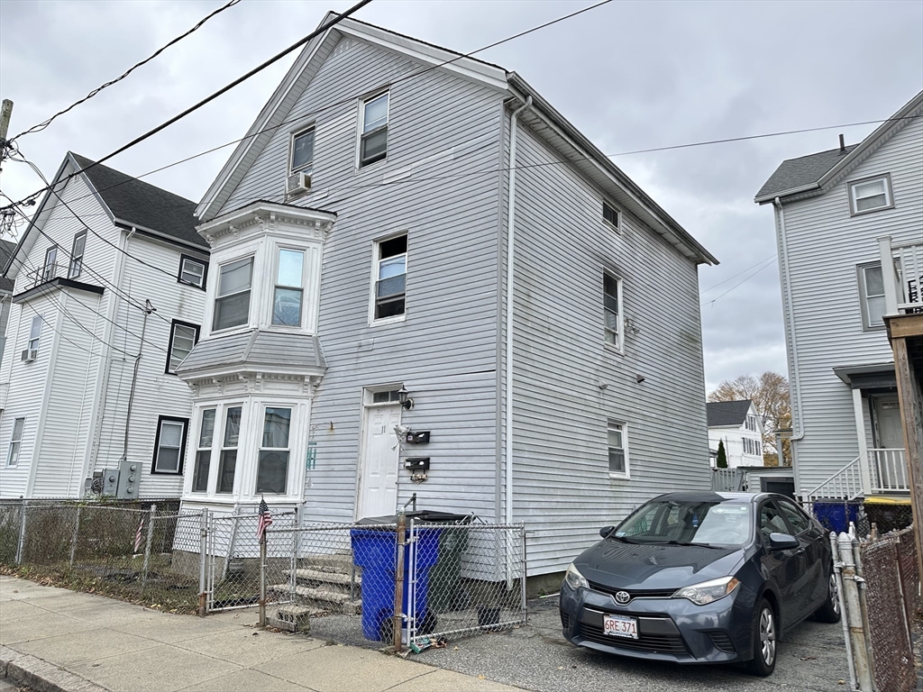 11 Foster Street Fall River, MA 02721 - Photo 3 of 15 a view of a white house with many windows and couches