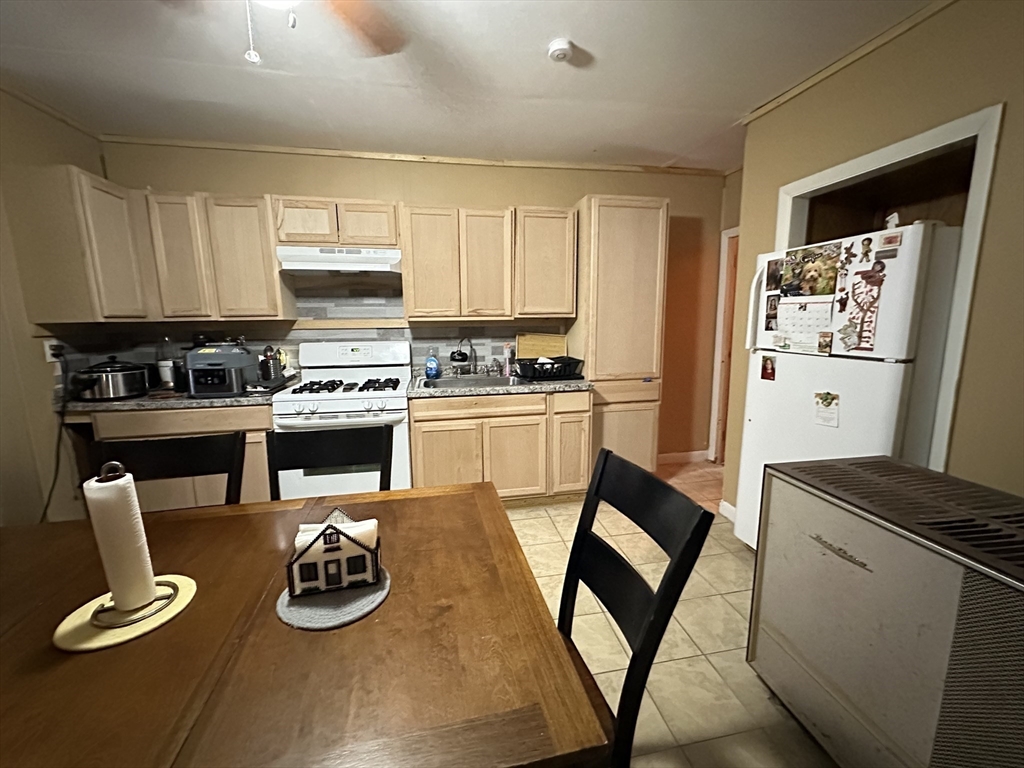 11 Foster Street Fall River, MA 02721 - Photo 4 of 15 a kitchen with sink refrigerator and stove