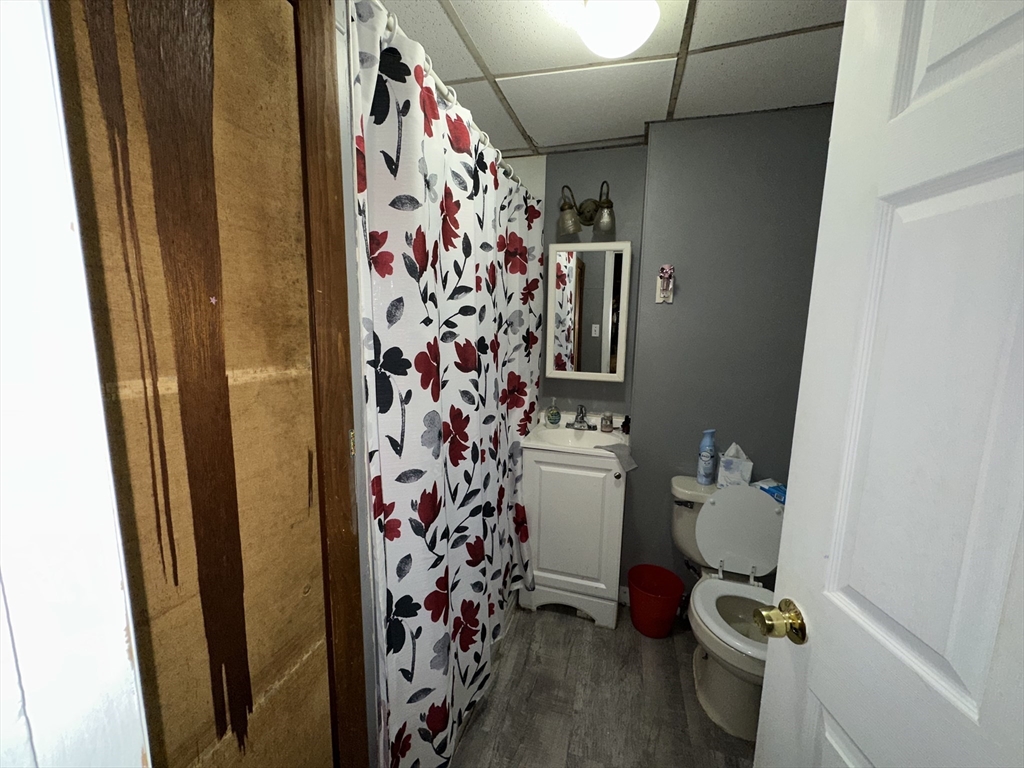 11 Foster Street Fall River, MA 02721 - Photo 8 of 15 a bathroom with a toilet and a shower curtain