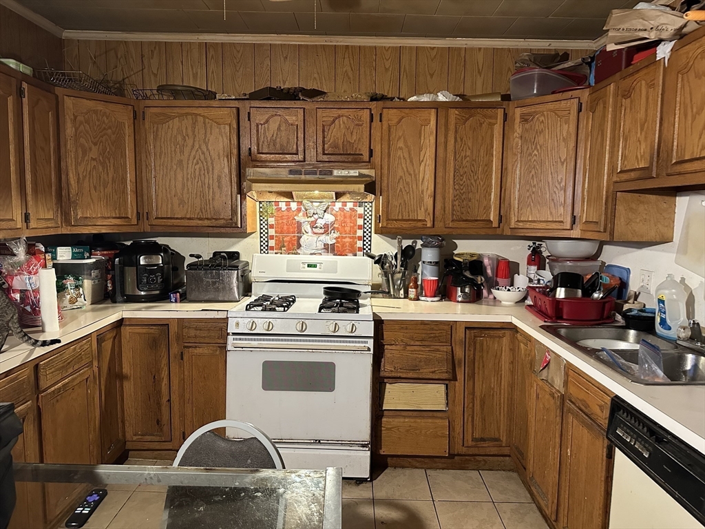 11 Foster Street Fall River, MA 02721 - Photo 10 of 15 a kitchen with a stove a sink and cabinets