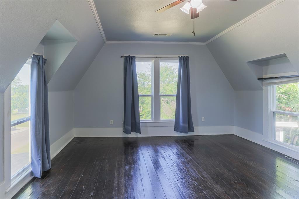 453 East Marshall Street Van Alstyne, TX 75495 - Photo 23 of 30 an empty room with wooden floor and windows