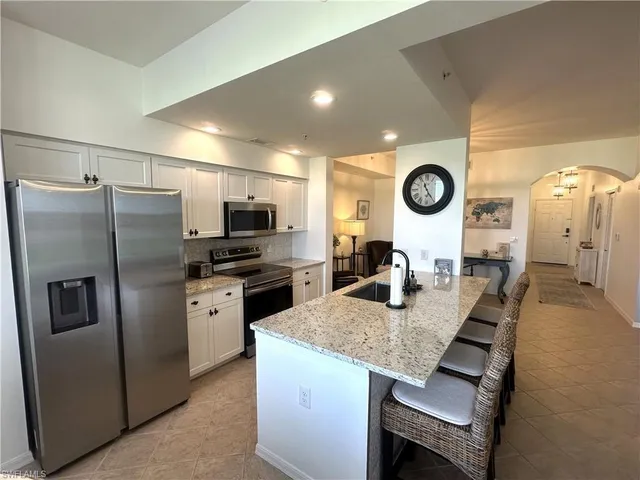 a kitchen with refrigerator and microwave