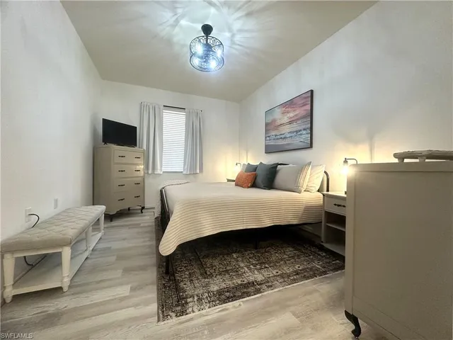 a bedroom with a bed dresser and a window