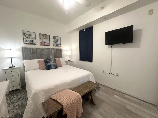 a bedroom with a bed and a flat screen tv