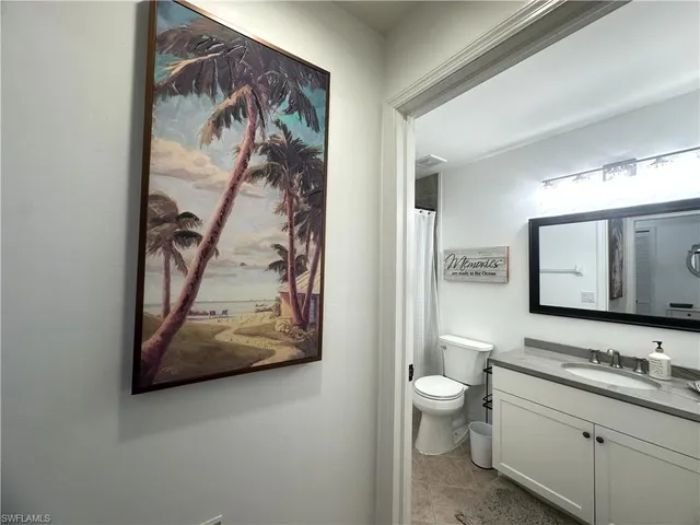 a bathroom with a toilet a sink and a mirror