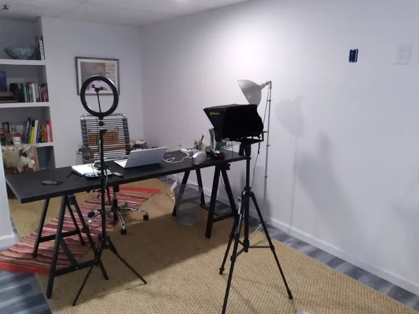 a view of a workspace room with furniture and wooden floor