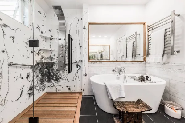 a white bath tub sitting next to a bathroom sink