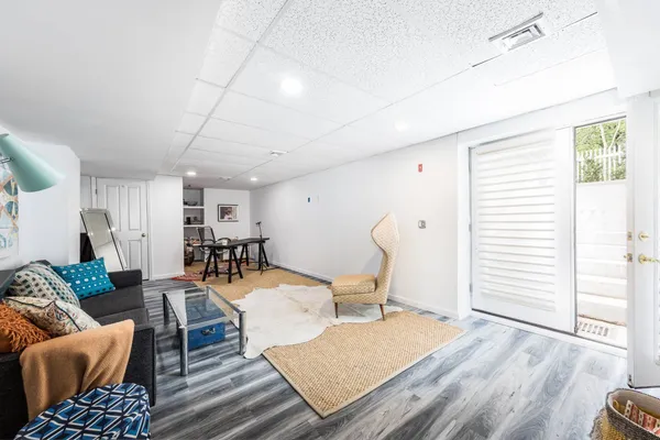 a living room with furniture and wooden floor