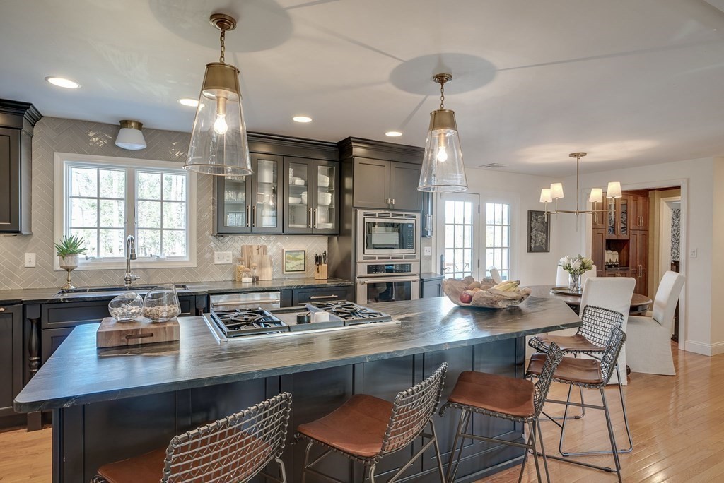 6 Phaeton Circle Andover, MA 01810 - Photo 11 of 42 a kitchen with a table chairs stove and kitchen island