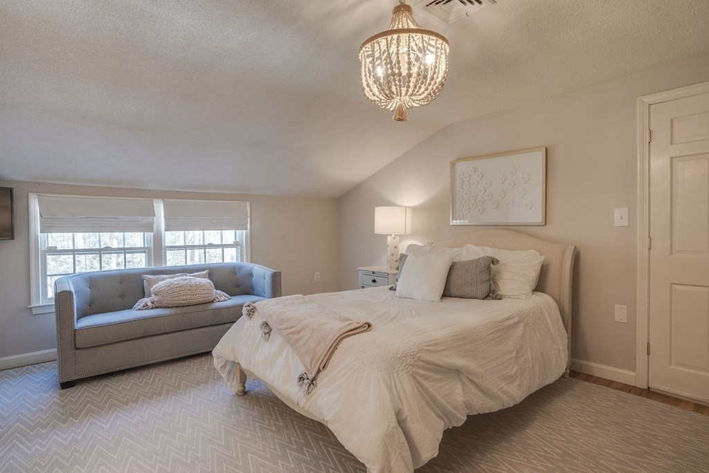 6 Phaeton Circle Andover, MA 01810 - Photo 32 of 42 a bedroom with bed and a chandelier