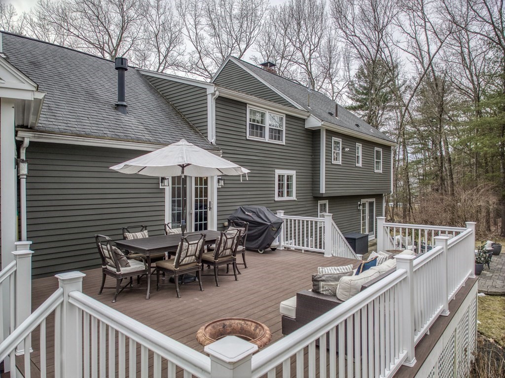 6 Phaeton Circle Andover, MA 01810 - Photo 4 of 42 a view of a patio with couches table and chairs and wooden floor