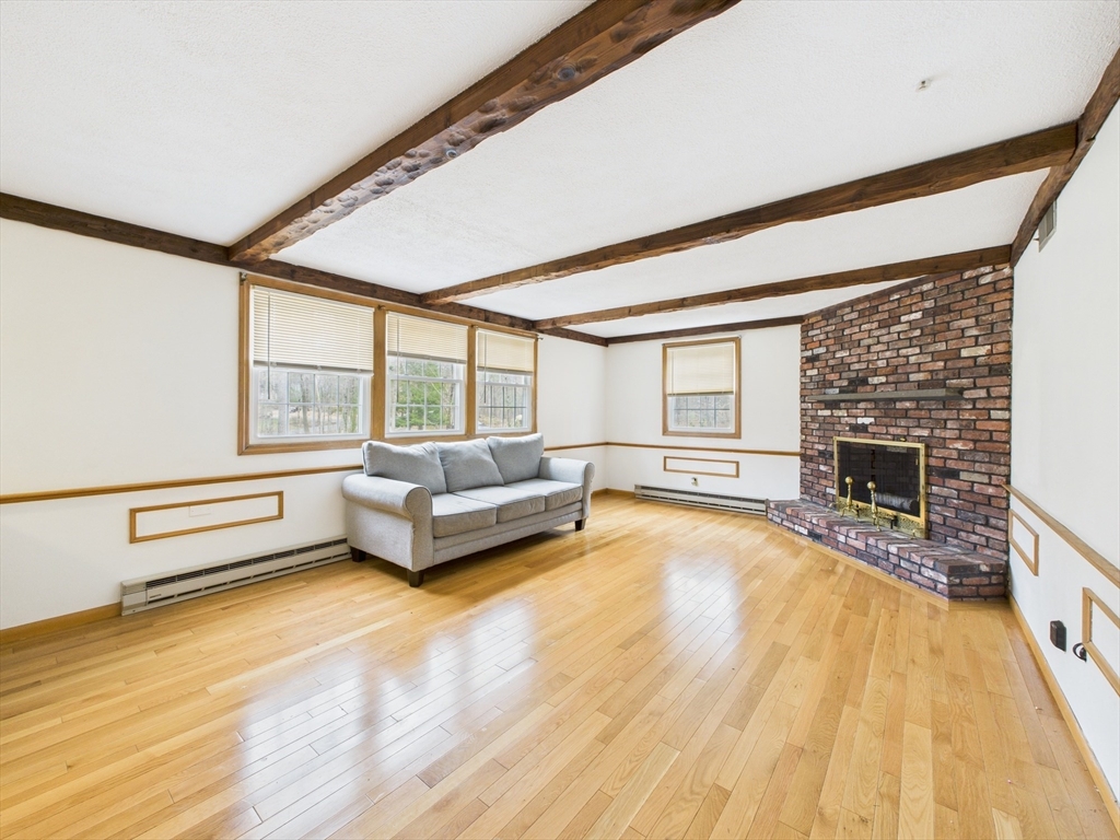 215 Stoney Lea Road Dedham, MA 02026 - Photo 13 of 27 a living room with furniture and a fireplace