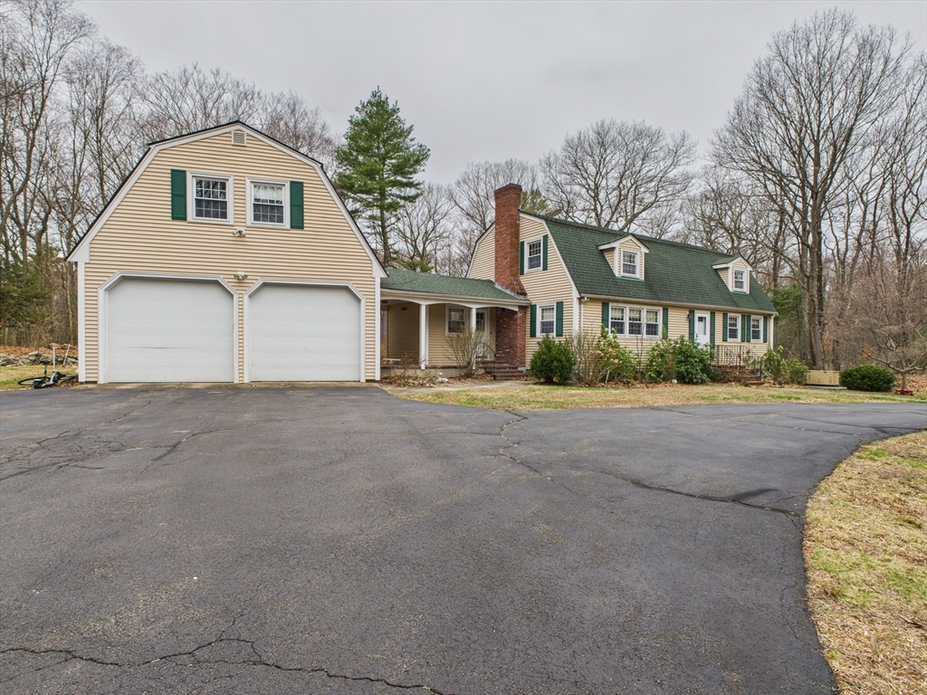 215 Stoney Lea Road Dedham, MA 02026 - Photo 2 of 27 a front view of a house with a yard and garage