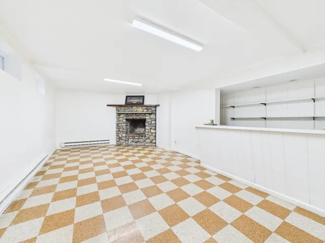 a bedroom with a bed and a black white checkered floor
