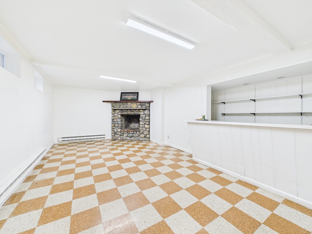 215 Stoney Lea Road Dedham, MA 02026 - Photo 22 of 27 a bedroom with a bed and a black white checkered floor