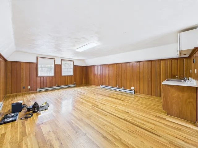 a view of a room with wooden floor and a sink