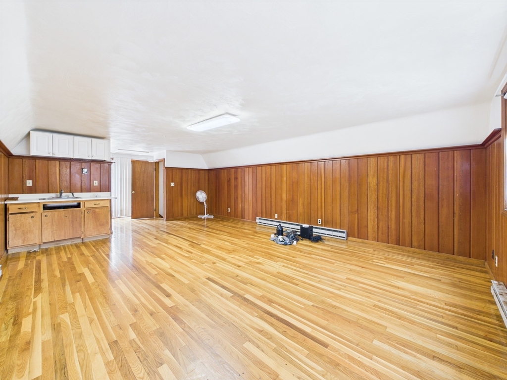 215 Stoney Lea Road Dedham, MA 02026 - Photo 24 of 27 a view of a room with wooden floor and furniture