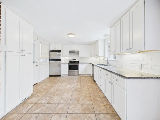 a large kitchen with cabinets and stainless steel appliances
