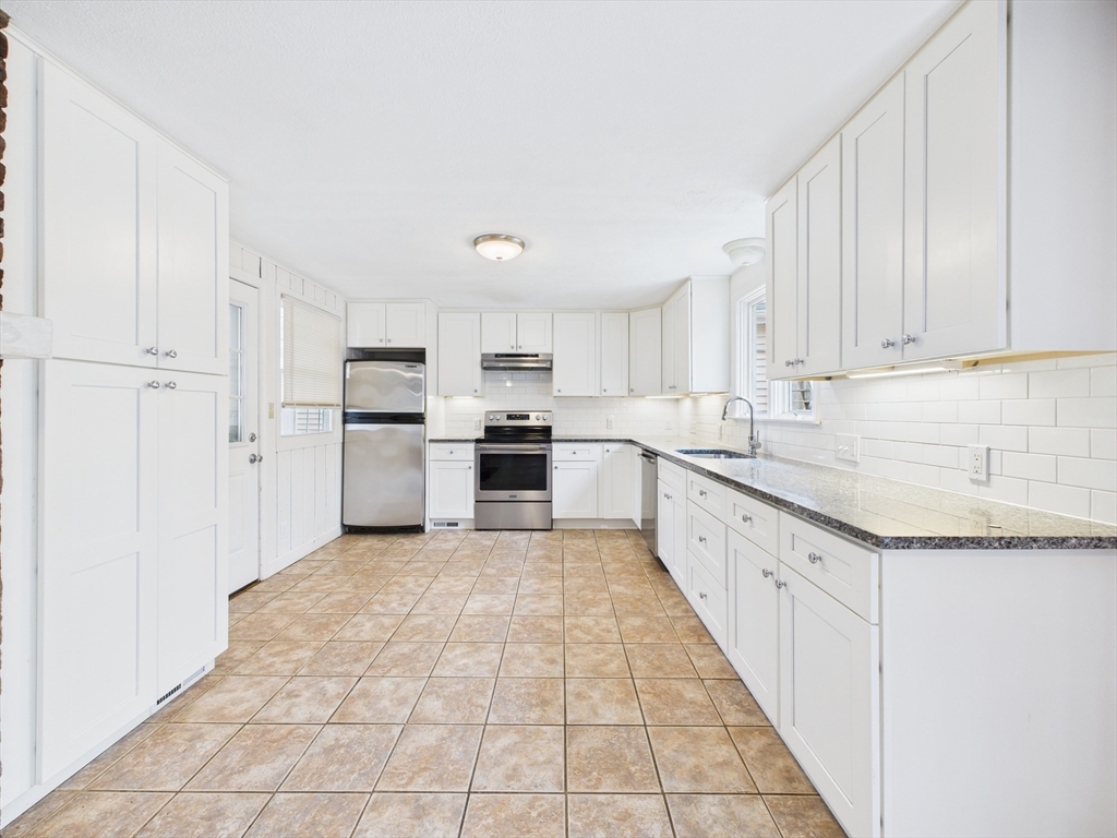 215 Stoney Lea Road Dedham, MA 02026 - Photo 4 of 27 a large kitchen with cabinets and stainless steel appliances