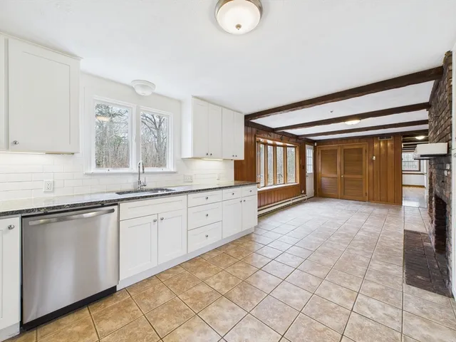 a spacious bathroom with a granite countertop sink and a mirror