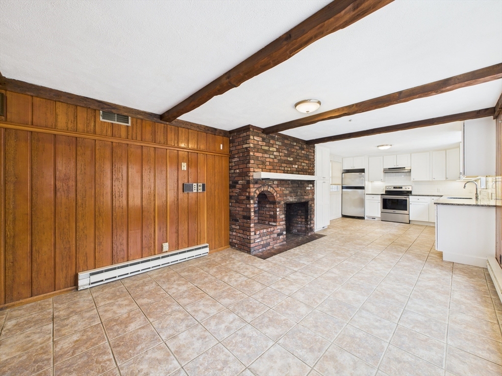 215 Stoney Lea Road Dedham, MA 02026 - Photo 6 of 27 a view of a livingroom with furniture and a fireplace