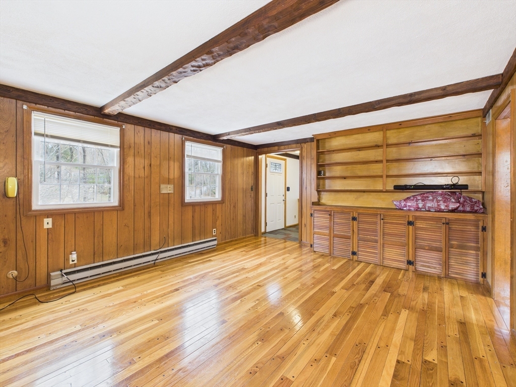215 Stoney Lea Road Dedham, MA 02026 - Photo 8 of 27 a view of an empty room with wooden floor and a window