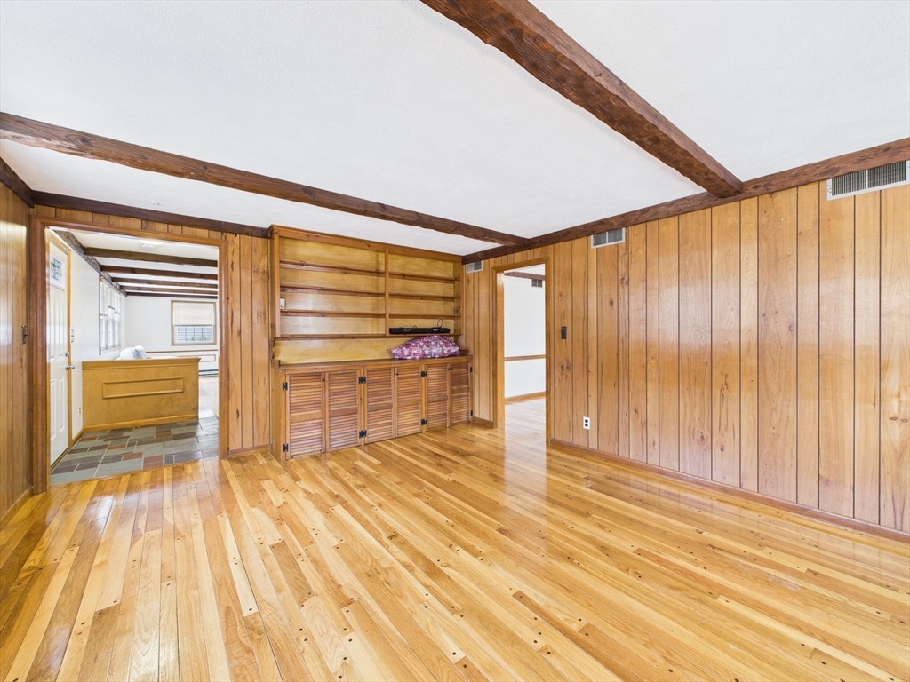 215 Stoney Lea Road Dedham, MA 02026 - Photo 9 of 27 a view of an empty room with wooden floor and a window