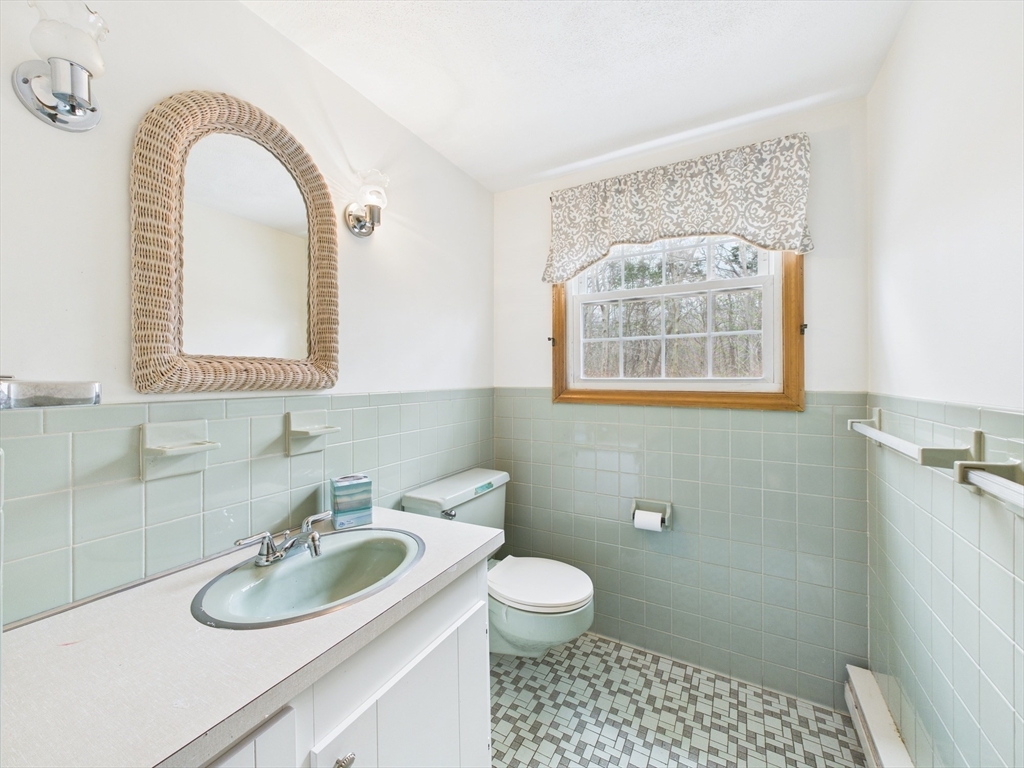 215 Stoney Lea Road Dedham, MA 02026 - Photo 10 of 27 a bathroom with a sink toilet and a window