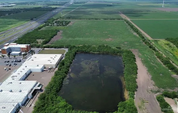 a view of a water pond with green space