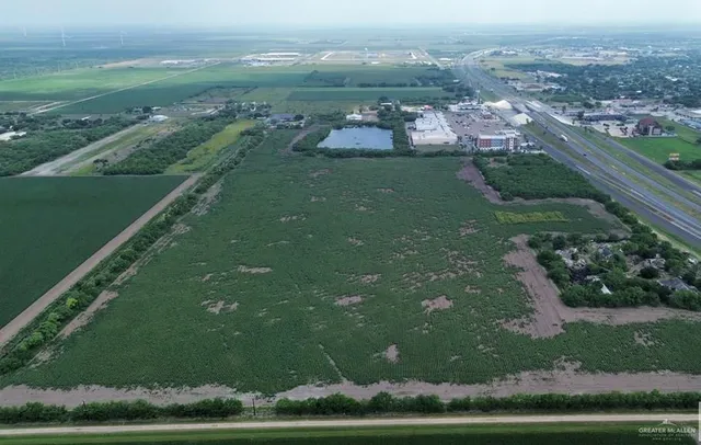 an aerial view of green landscape with trees houses and mountain view