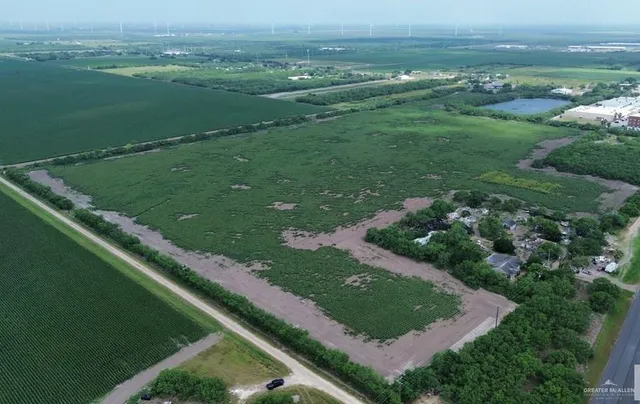 an aerial view of green landscape with trees houses and mountain view