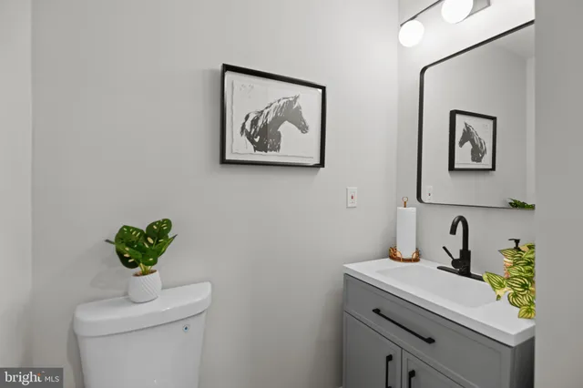 a bathroom with a sink a mirror and vanity