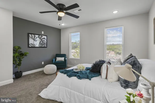 a bedroom with a bed and a large window