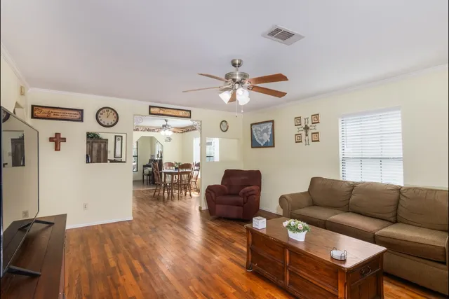 a living room with furniture and wooden floor
