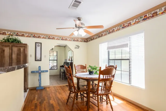 a dining room with furniture window and wooden floor