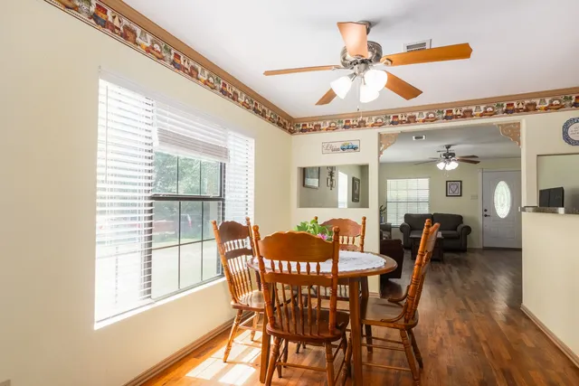 a dining room with furniture and window
