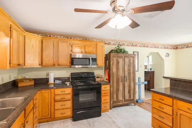 a kitchen with stainless steel appliances a refrigerator sink and stove