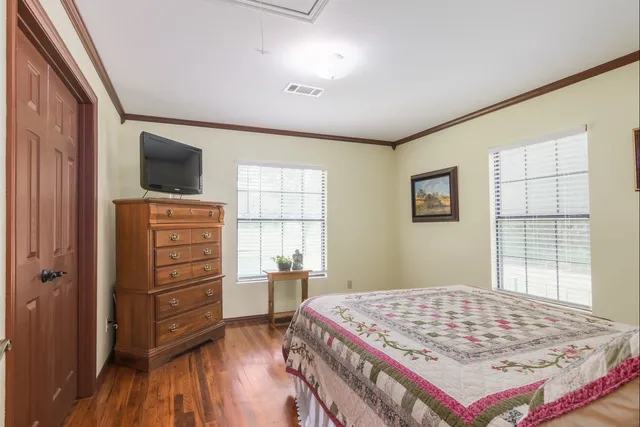 a bedroom with a bed and a television