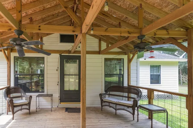 a balcony with furniture and a potted plant