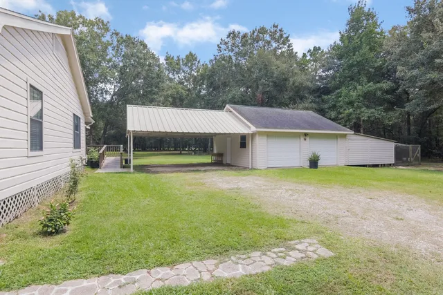a house that has a big yard with wooden fence