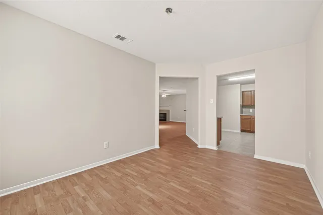a view of a big room with wooden floor and a bathroom