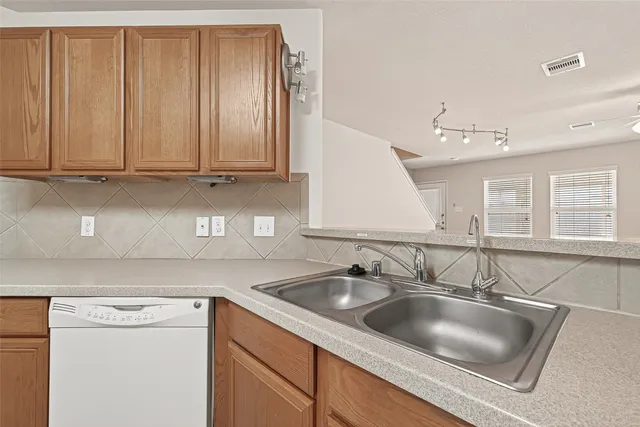 a kitchen with a sink cabinets and a window