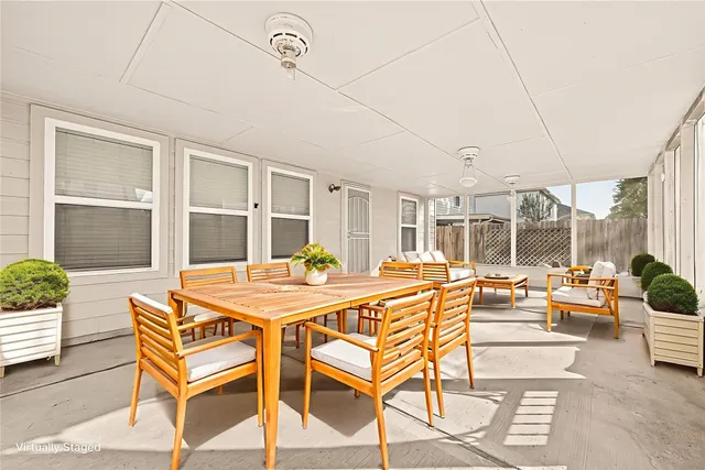 a view of a dining room with furniture large windows and wooden floor