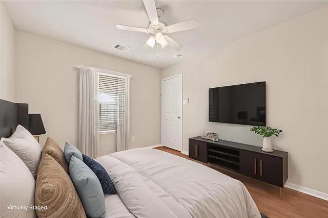 a bedroom with a bed and a flat screen tv