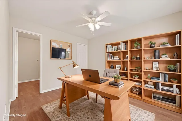 a work room with furniture and a bookshelf