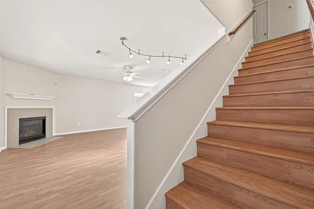 a view of entryway and hall with wooden floor