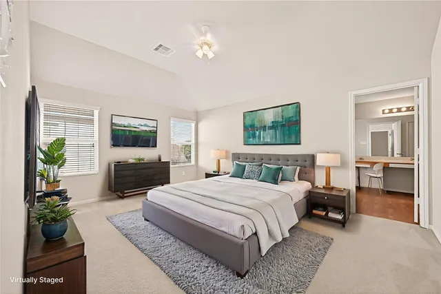 a bedroom with a large bed and a flat screen television