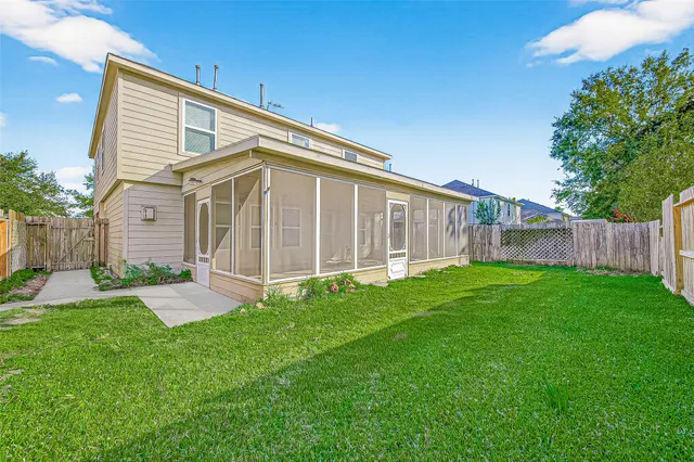 a view of a house with a backyard